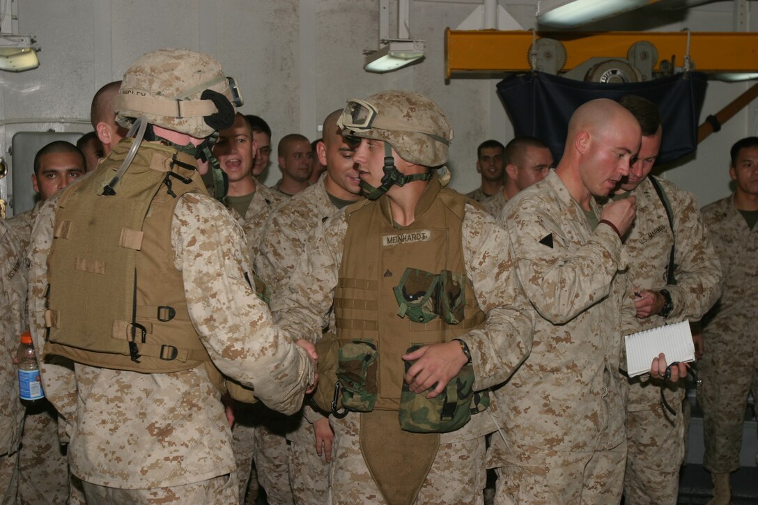 Cpl. Jeffrey Gibson, an infantryman and native of Anoka, Minn., is congratulated by fellow Marines in his unit after winning one of the small arms competitions going on here. Gibson is member of Charlie Company, Battalion Landing Team 1/1, 15th Marines Expeditionary Unit (Special Operations Capable).