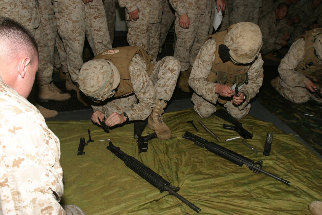 Fellow Marines cheer for participants of Charlie Company's small arms disassembly and reassembly competition. The company is part of Battalion Landing Team 1/1, 15th Marine Expeditionary Unit (Special Operations Capable).