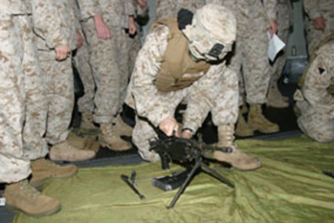 Corporal Damien Longley a native of Eureka, Nev. and a Marine with Charlie Company, Battalion Landing Team 1/1, 15th Marine Expeditionary Unit (Special Operations Capable) races to reassemble an M-249 Squad Automatic Weapon during a small arms disassemble and reassemble competition put on by his unit as part of their training here.
