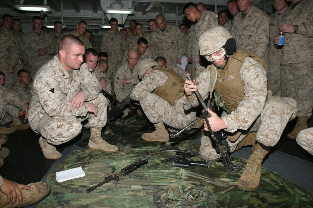 Lance Cpl. Russell Reeves, a Brookston, Ind. native and member of Charlie Company, Battalion Landing Team 1/1, 15th Marine Expeditionary Unit (Special Operations Capable), rushes to reassemble an M-249 Squad Automatic Weapon as he takes part in a race against time and his fellow Marines in a weapons competition put on here.