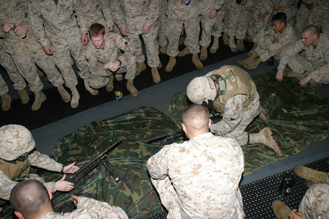 Cpl. Richey Bigger of Tulsa, Okla. and Lance Cpl. William Crow of Boron, Calif. both Marines with Charlie Company, Battalion Landing Team 1/1, 15th Marine Expeditionary Unit (Special Operations Capable), race to disassemble and reassemble a M-240G Medium Machinegun during a weapons competition put on here as part of their training.