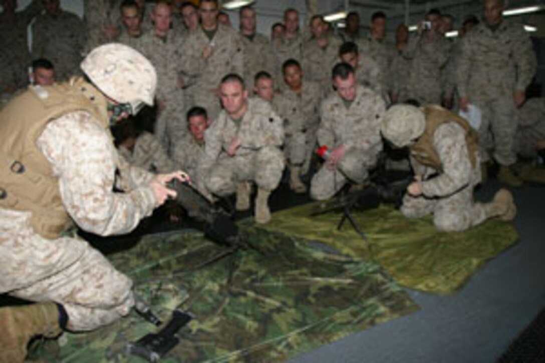 Cpl. Richey Bigger of Tulsa, Okla. and Lance Cpl. William Crow of Boron, Calif. with Charlie Co., Battalion Landing Team 1/1, 15th Marine Expeditionary Unit (Special Operations Capable),  take part in a disassemble-reassemble competition using an M-240G medium machinegun here as part of their training.