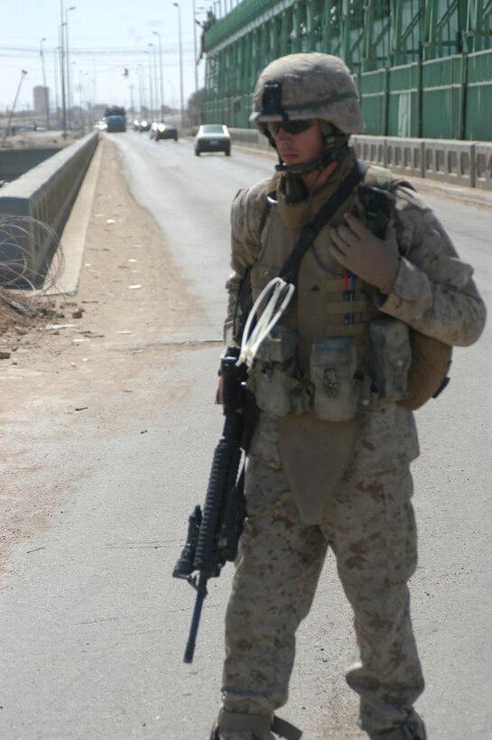AR RAMADI, Iraq (March 24, 2005) - Twenty-year-old Cpl. Derek M. Hildman, machine gunner, Company C, 1st Battalion, 5th Marine Regiment, works the entry control point on the edge of the South Bridge here. The 2003 Kenosha Military Academy graduate, who enlisted in the Corps at the age of 17, has wanted to serve his country as a Marine from the time he was a child growing up in his hometown of Kenosha, Wis. He was meritoriously promote to corporal and is on his second deployment to Iraq in support of Operation Iraqi Freedom. Photo by Cpl. Tom Sloan