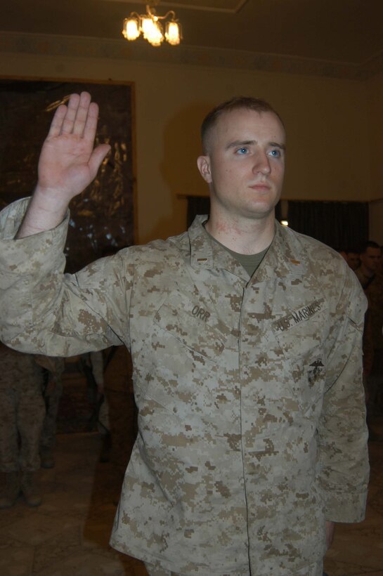 CAMP HURRICANE POINT Ar Ramadi, Iraq (May 23, 2005) - Second Lieutenant Douglas R. Orr, the platoon commander of 4th Platoon, Company A, 1st Combat Engineer Battalion, which is in direct support of 1st Battalion, 5th Marine Regiment, raises his right hand and takes his oath of office during a ceremony here. The 23-year-old from Ridgefield, Conn., was promoted to the rank of first lieutenant along with three other Marine officers with 1st Battalion, 5th Marines. Orr graduated from the United States Navel Academy Annapolis, Md., and holds a Bachelors of Science degree in political science. Photo by: Cpl. Tom Sloan