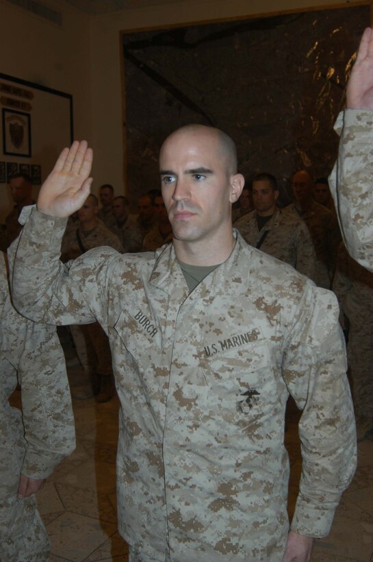CAMP HURRICANE POINT Ar Ramadi, Iraq (May 23, 2005) - Second Lieutenant Adam W. Burch, platoon commander of 5th Platoon, Company W, 1st Battalion, 5th Marine Regiment, raises his right hand and takes his oath of office during a ceremony here. The 28-year-old from Saratoga, N.Y., was promoted to the rank of first lieutenant along with three other Marine officers with 1st Battalion, 5th Marines. The prior Petty Officer 2nd Class is a 2003 Citadel Military College of South Carolina graduate and holds a Bachelors of Arts degree in political science. Photo by: Cpl. Tom Sloan