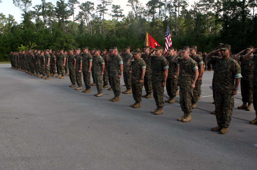 MARINE CORPS BASE CAMP LEJEUNE, N.C. -- All the Marines who were getting ready to be awarded Purple Hearts and other combat awards hold a hand salute as the National Anthem is played at the beginning of the ceremony.  Traditions such as this are kept to the highest of standards in Marine Corps ceremonies.  Official U.S. Marine Corps photo by Cpl. Athanasios L. Genos