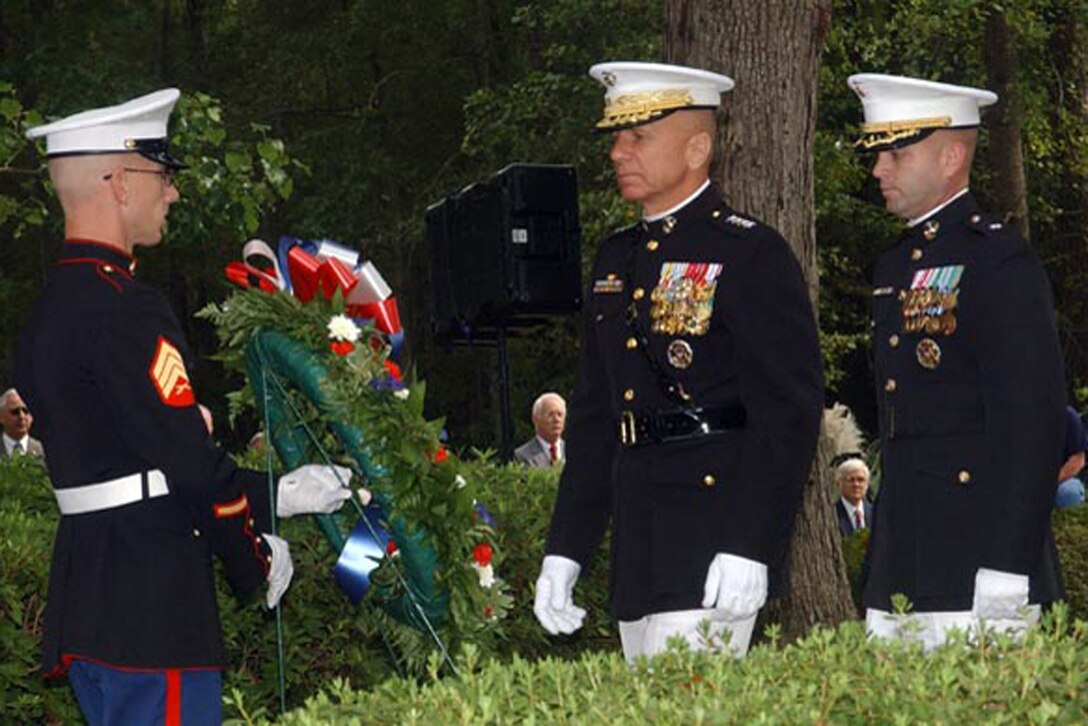 MARINE CORPS BASE CAMP LEJEUNE, N.C. - General Michael W. Hagee, Commandant of the Marine Corps, and Lt. Col. James S. Alley, commanding officer of 1st Battalion, 8th Marine Regiment, 2d Marine Division, march toward the wall of the monument to lay the ceremonial wreath.  The Beirut Memorial Observance Ceremony is held annually to remember those who lost their lives Oct. 23, 1983. Photo by:  Lance Cpl. Adam Johnston