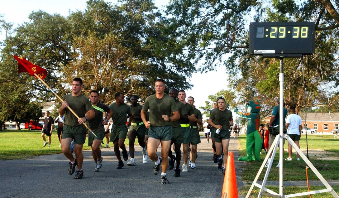 A platoon of Marines from 2nd Supply Bn., 2nd Force Service Support Group crosses the finish line after the CFC 5K Fun Run, Sep. 23.