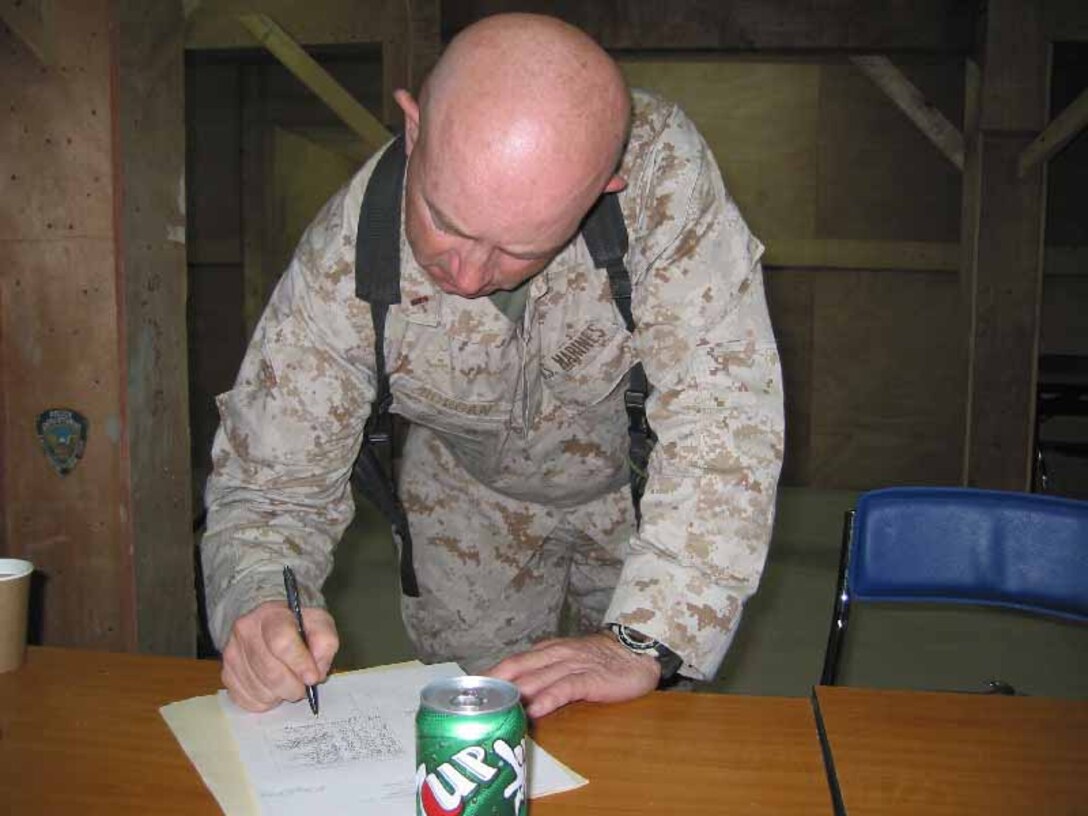 Sergeant 1st Class Eldon Casner, and his son, Army Pfc. Michael Casner, celebrate Thanksgiving with a special dinner in a security guard tent at Al Asad, Iraq, Nov. 24.