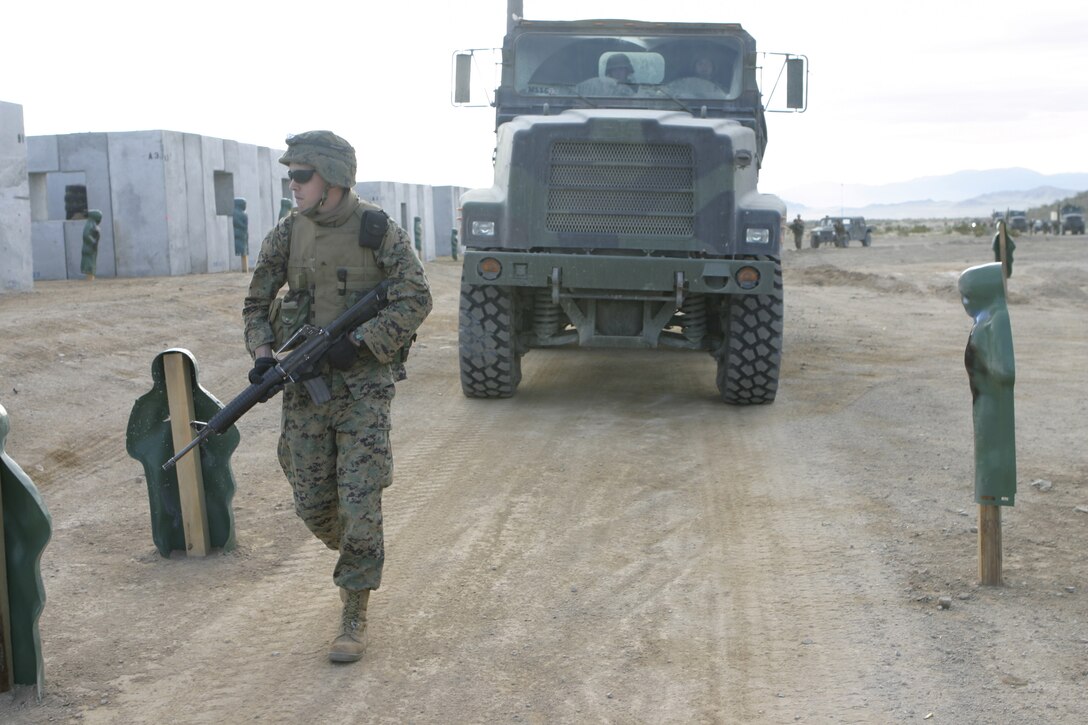 MARINE CORPS AIR-GROUND COMBAT CENTER TWENTYNINE PALMS, Calif. - A Marine with 1st Battalion, 6th Marine Regiment patrols through a mock Iraqi village here as he looks for insurgents.  The unit conducted a Revised Combined Arms Exercise to prepare for deployment to Iraq in March.