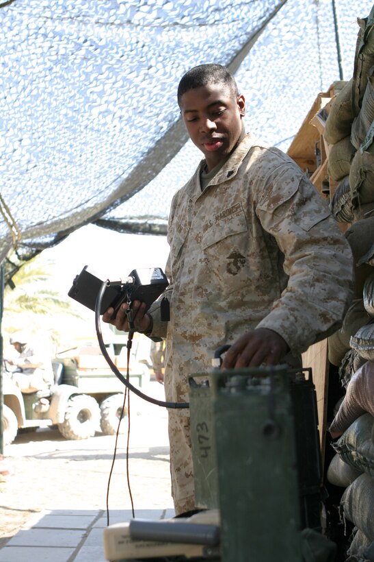 CAMP BLUE DIAMOND, AR RAMADI, Iraq -- Corporal Dexter Brown, a 20-year-old field radio operator, West Memphis, Ark. native and 2002 graduate of West Memphis High School, teaches Marines of Headquarters Battalion, 2nd Marine Division how to use the Personnel Radio Component 119 (PRK-119) system, March 24.  The VHF radio is the Corps' main mode of communication in ground combat operations for Operation Iraqi Freedom.  U.S. Marine Corps photo by Sgt. Stephen D'Alessio (RELEASED)