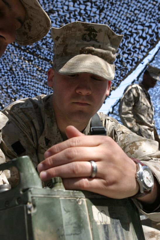 CAMP BLUE DIAMOND, AR RAMADI, Iraq -- Lance Cpl. Carlos Garza, a 20-year-old Houston, Texas native and administration clerk with Headquarters Battalion, learns how to use the Personnel Radio Component 119 (PRK-119) system, March 24.  The VHF radio is the Corps' main mode of communication in ground combat operations for Operation Iraqi Freedom.  U.S. Marine Corps photo by Sgt. Stephen D'Alessio (RELEASED)