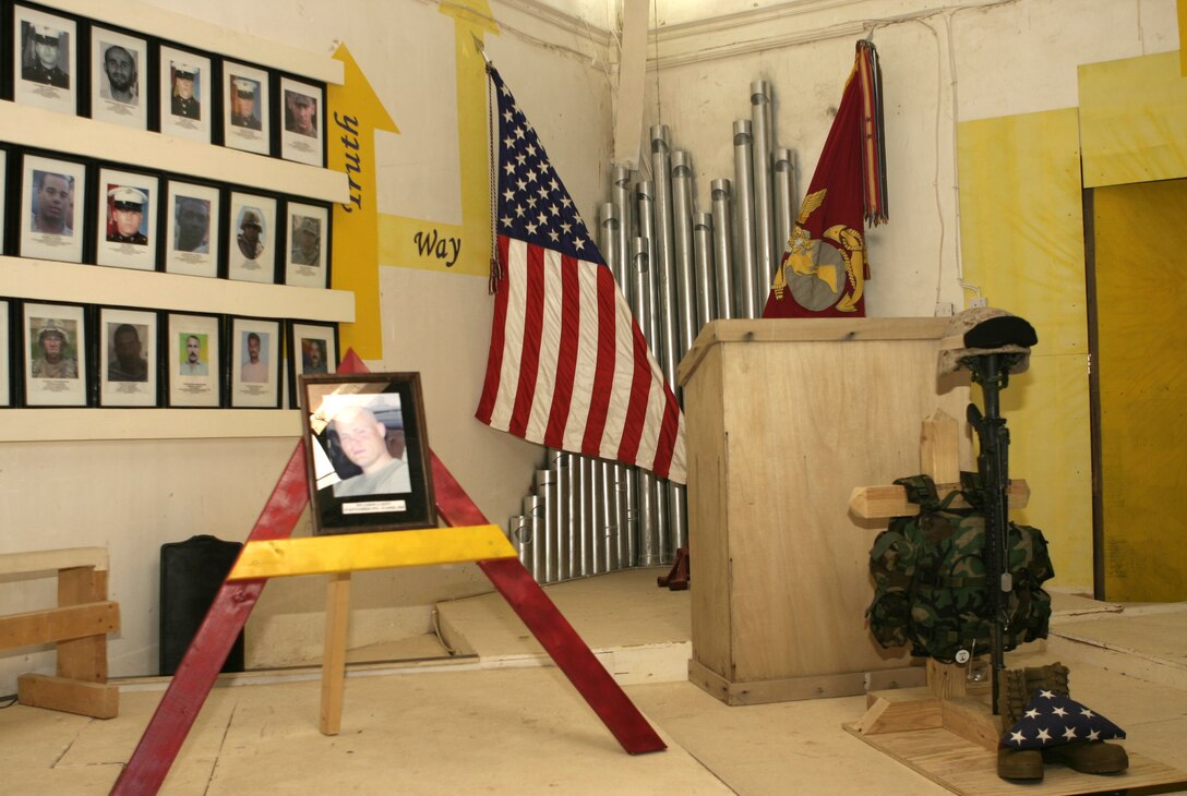 CAMP BAHARIA, Iraq - Hospitalman Aaron A. Kent's photo and gear display stand inside the chapel here after his memorial service April 24.  The 28-year-old Portland, Ore. native passed away April 23 when his vehicle struck an improvised explosive device in a roadway outside Fallujah.