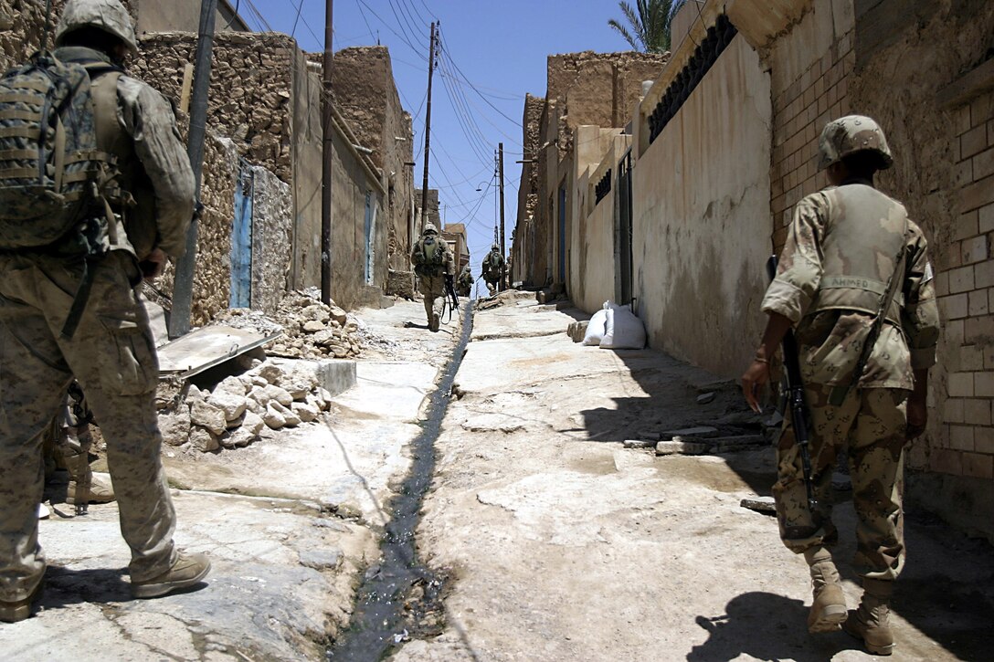 Hit, Al Anbar, Iraq (July 22, 2005)-- Marines with Company "K", 3rd Battalion, 25th Marine Regiment and soldiers with Iraq Intervention Force patrol the streets. (Official USMC Photo by Corporal Ken Melton)