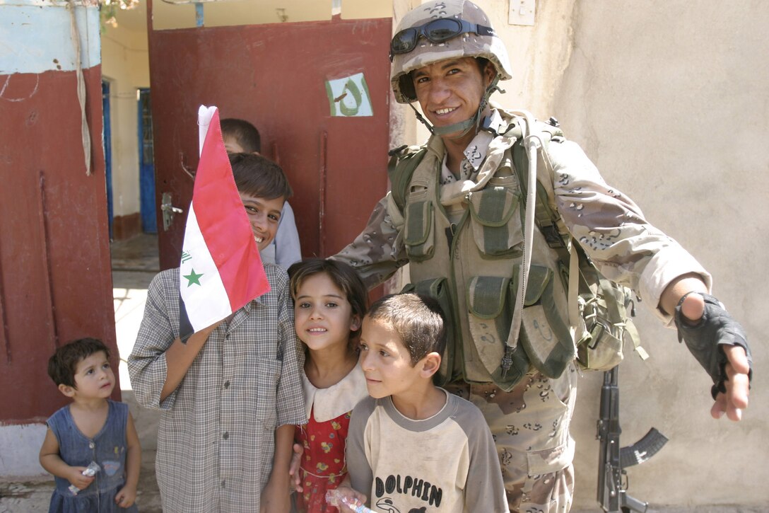 Hit, Al Anbar, Iraq (July 22, 2005)--Iraq Intervention Force soldier interacts with children while on patrol. (Official USMC Photo by Corporal Ken Melton)