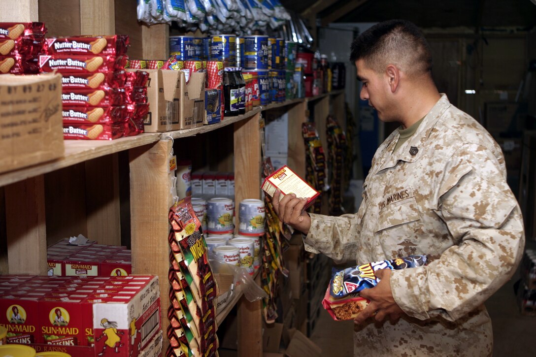 CAMP BAHARIA, Iraq - Staff Sgt. Candelario Martinez, a Marine with 1st Battalion, 6th Marine Regiment, browses for snacks inside the Baharia Post Exchange Aug. 24.  The camp's PX offers Marines here and throughout Northern Fallujah electronics, health and comfort items, and serves approximately 2,000 customers every week.
