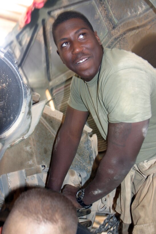 CAMP AL QA'IM, Iraq - Dallas, Ga., native Cpl. Richard E. Scarlett III, works on a hummer here.  The graduate of Quantico High School enlisted in the Marine Corps to follow in his father's footsteps, who retired as a Marine master sergeant.  (Official U.S. Marine Corps photo by Sgt. Jerad W. Alexander)