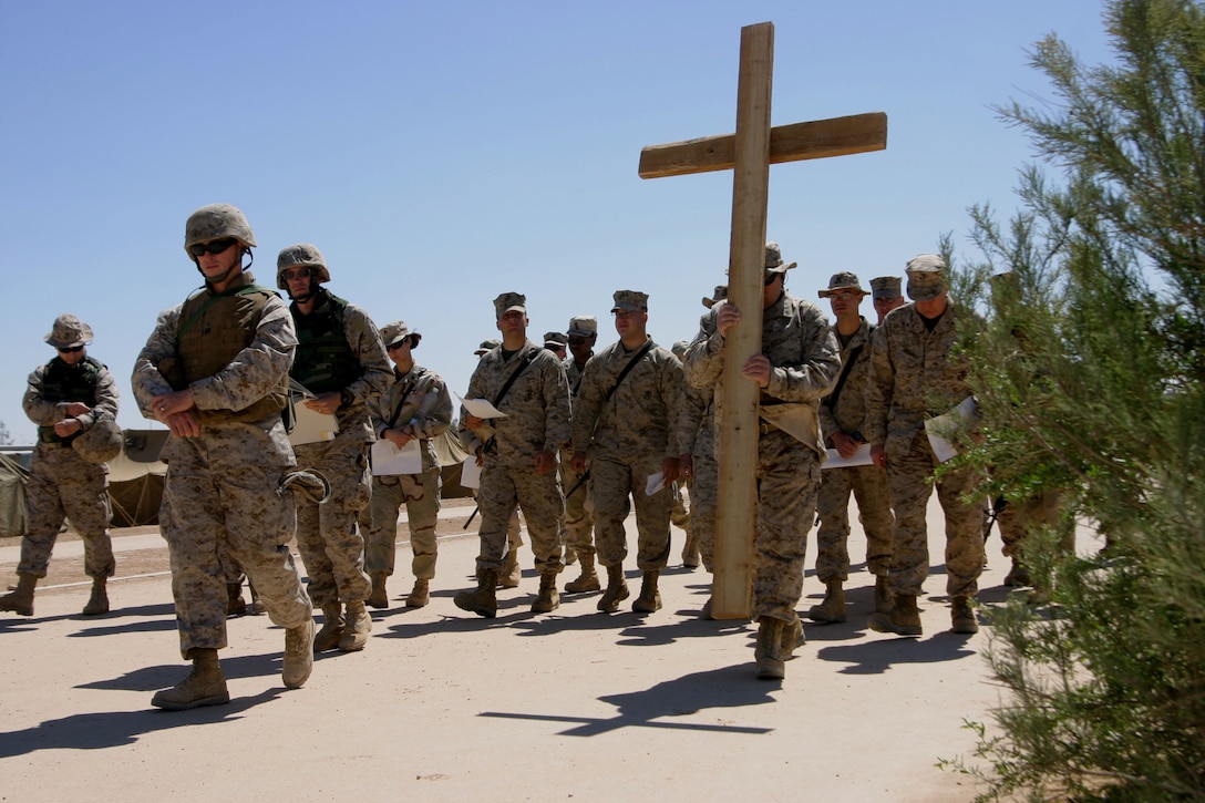 AL ASAD, Iraq -- Service members carry a cross and walk to one of the various stations to meditate on a different scene from the Passion of Christ on March 25.  Hundreds took time out of their busy schedules and celebrated Good Friday and Easter while here in support of Operation Iraqi Freedom.