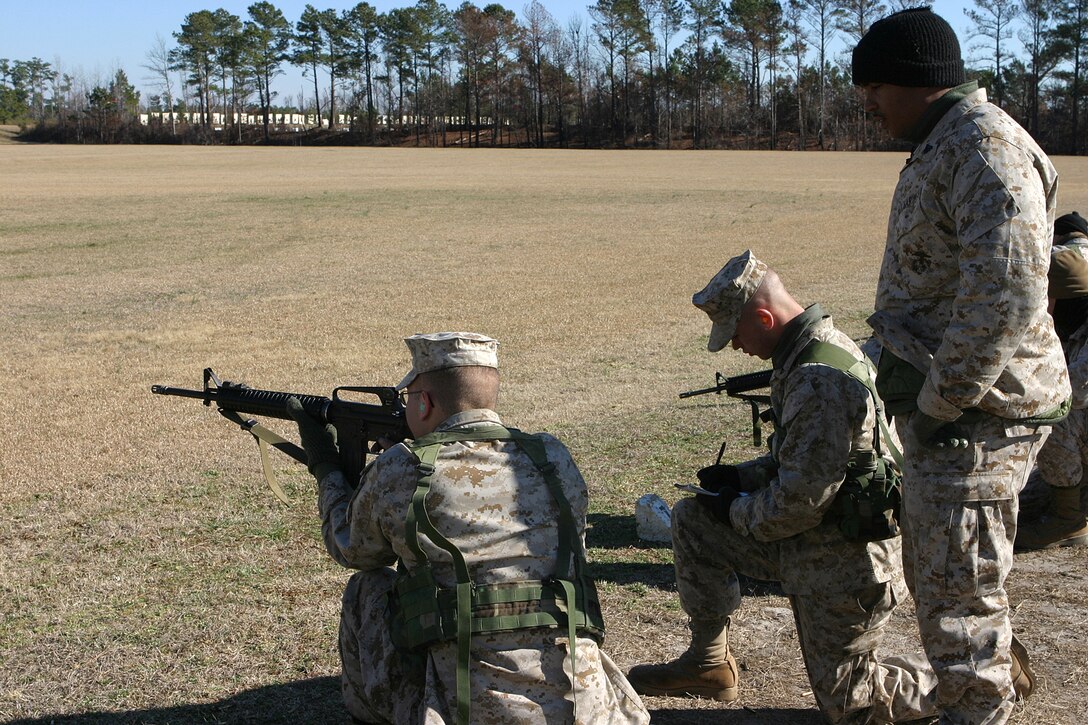 MARINE CORPS BASE CAMP LEJEUNE, N.C. (Jan. 25, 2004)-Corporal Kendrick R. Victoria, a 2d Marine Division Marksmanship Training Unit instructor and Bronx, N.Y. native observes a Marine while he shoots during a recent coaches' course at Stone Bay here.