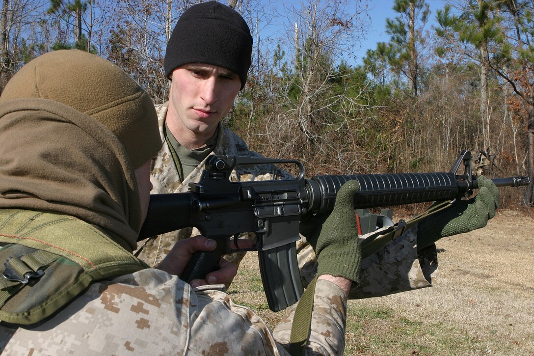 MARINE CORPS BASE CAMP LEJEUNE, N.C. (Jan. 25, 2004) - Corporal Josh D. Alford, a 2d Marine Division Marksmanship Unit instructors a Marine on proper technique during a recent coaches' course here. Alford, a Knoxville, Tenn. native has spent the last year teaching Marines about marksmanship with MTU.