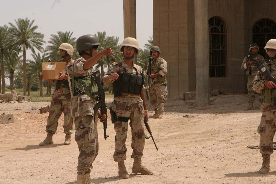 AL KARMAH, IRAQ -- The company commander for the Iraqi Security Forces Company, who are attached to Lima Company, 3rd Battalion, 8th Marine Regiment, prepare to go out on their own giving out medical supplies to local families.  The ISF have been taking on more responsibility and going on their own patrols with guidance from their Marine counterparts.  Official U.S. Marine Corps photo by Lance Cpl. Athanasios L. Genos