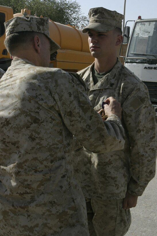 CAMP AL QA'IM, Iraq (June 25, 2005)- Cpl. Matt Orth, a 22-year-old scout sniper with 3rd Battalion, 2nd Marine Regiment receives the Purple Heart from Gen. Nyland, the assistant commandant of the Marine Corps here June 25. The Clearwater, Fla., native received the Purple Heart for wounds received during attacks at Camp Gannon in Husaybah, Iraq, where he suffered a concussion and bruised ribs. (Official U.S. Marine Corps photo by Lance Cpl. Lucian Friel (RELEASED)