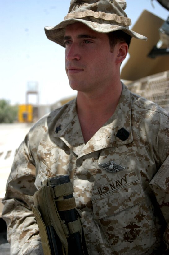 CAMP HURRICANE POINT Ar Ramadi, Iraq (July 24, 2005) - Petty Officer 2nd Class Benjamyn Savard, a hospitalman and the senior line corpsman for Company W, 1st Battalion, 5th Marine Regiment, recently earned his Fleet Marine Force pin and was awarded it during a ceremony here July 24. The 29-year-old from San Diego used every chance he had to study the FMF books so he could pass the test. Over the course of 45 days, when he wasn't on missions in the Al Anbar capital with his Marine comrades, he devoted his time to studying. Earning the FMF pin symbolizes his knowledge of Navy and Marine Corps history, customs and courtesies and Marine Corps and amphibious operations. Savard enlisted in the Navy after graduating from Cosby High School in 1994. He was 17-years-old. This is his second deployment to Iraq supporting Operation Iraqi Freedom in as many years. Photo by: Cpl. Tom Sloan