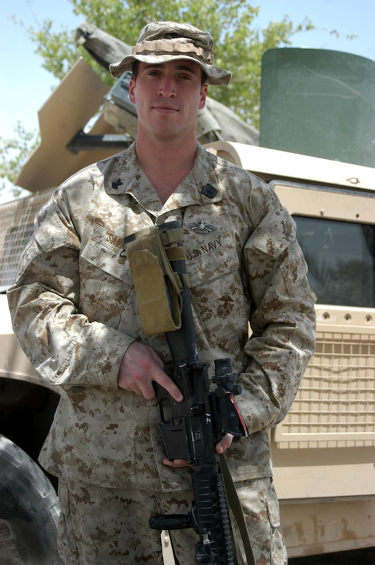 CAMP HURRICANE POINT Ar Ramadi, Iraq (July 24, 2005) - Petty Officer 2nd Class Benjamyn Savard, a hospitalman and the senior line corpsman for Company W, 1st Battalion, 5th Marine Regiment, recently earned his Fleet Marine Force pin and was awarded it during a ceremony here July 24. The 29-year-old from San Diego used every chance he had to study the FMF books so he could pass the test. Over the course of 45 days, when he wasn't on missions in the Al Anbar capital with his Marine comrades, he devoted his time to studying. Earning the FMF pin symbolizes his knowledge of Navy and Marine Corps history, customs and courtesies and Marine Corps and amphibious operations. Savard enlisted in the Navy after graduating from Cosby High School in 1994. He was 17-years-old. This is his second deployment to Iraq supporting Operation Iraqi Freedom in as many years. Photo by: Cpl. Tom Sloan