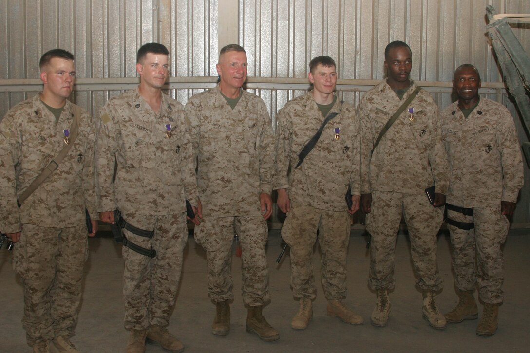 CAMP AL QA'IM, Iraq (July 25, 2005)- (From left to right) Cpl. Kyle Pimm, Gunnery Sgt. Charles Yannizzi, Gen. Michael W. Hagee, Lance Cpl. Patrick Jackson, Lance Cpl. Calvin Mitchum, and Sgt. Maj. of the Marine Corps John L. Estrada pose for a picture after a Purple Heart ceremony here July 25. (Official U.S. Marine Corps photo by Lance Cpl. Lucian Friel (RELEASED)