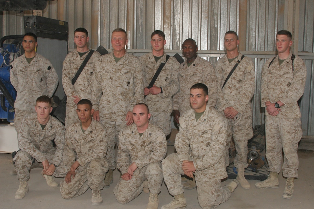 CAMP AL QA'IM, Iraq (July 25, 2005)- Commandant of the Marine Corps General Michael W. Hagee and Sergeant Major of the Marine Corps pose for a picture with Scout Sniper Platoon, 3rd Battalion, 2nd Marine Regiment during their visit here July 25. (Official U.S. Marine Corps photo by Lance Cpl. Lucian Friel (RELEASED)