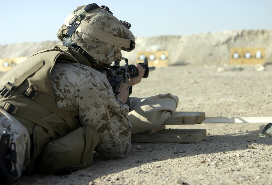 CAMP BAHARIA, Iraq - A corpsman with 1st Battalion, 6th Marine Regiment fires his M16A2 service rifle to acquire a battle sight zero here Aug. 7.  Several of the unit's 'docs' adjusted their rifles' sights before firing an M9 Beretta pistol qualification course to earn their service's pistol qualification ribbon.