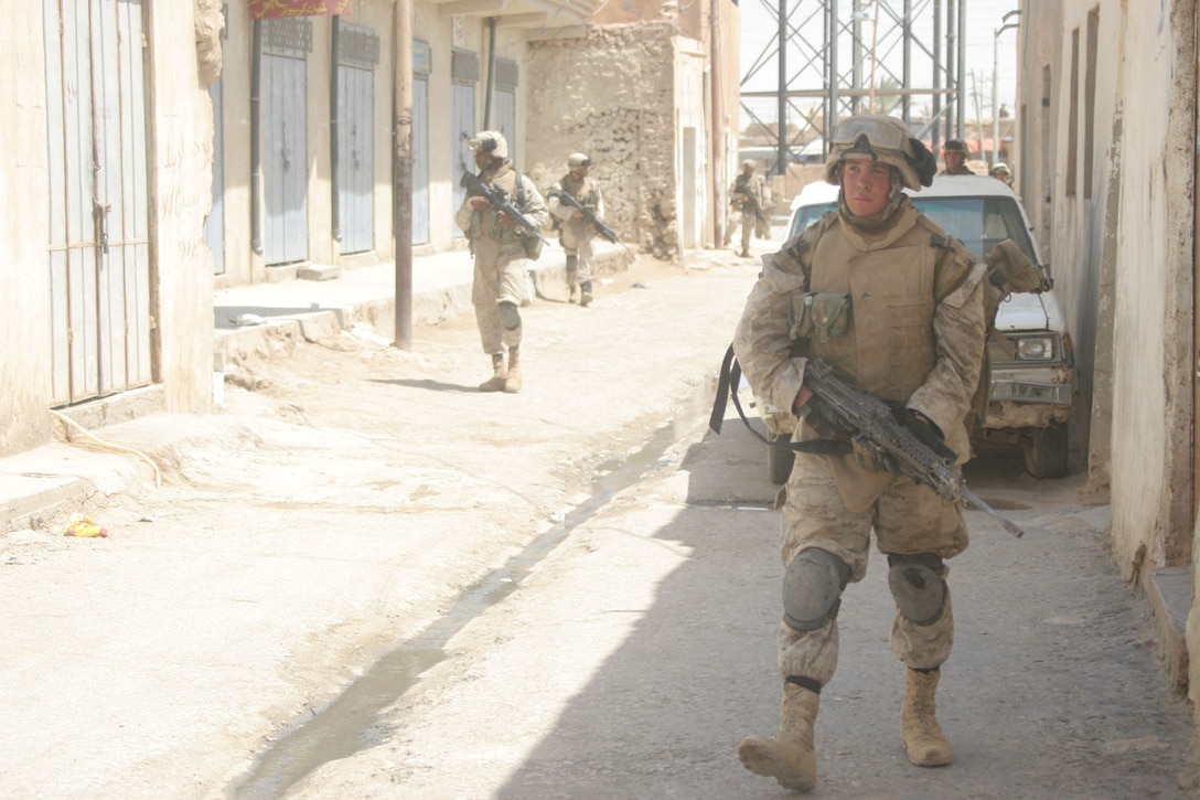 Marines with 1st Platoon, Company L, 3rd Battalion, 2nd Marine Regiment, Regimental Combat Team-2 patrol through the city to their next target during a mission here to capture high value individuals and disrupt insurgent activity in the city. The Marines captured 26 detainees during the half-day operation.