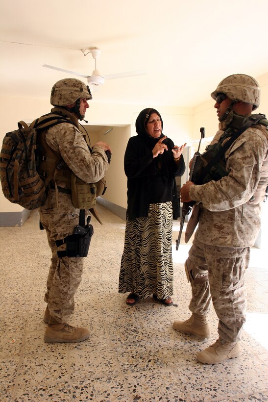 AR RAMADI, Iraq (September 25, 2005) - During a stop on a civil affairs group/information operations patrol, Gunnery Sgt. John Satanek, team chief for CAG team 4, speaks with the vice principal of a local school through an interpreter Sept. 25. The school seemed to be good repair and the vice principal said they didn't need any supplies, said Satanek. Photo by Cpl. Shane Suzuki