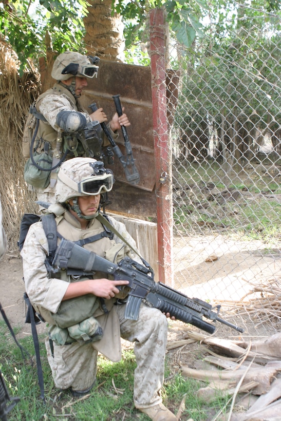 HADITHA, Iraq (May 25, 2005)- Marines with 3rd Squad, 3rd Platoon, Company K, 3rd Battalion, 2nd Marine Regiment, Regimental Combat Team-2 cut their way through obstacles using their breaching kit during a sweep of northern Haditha. Kilo Co. was supporting 3rd Bn., 25th Marines during Operation New Market to clear the city. (Official U.S. Marine Corps photo by Lance Cpl. Lucian Friel (RELEASED)