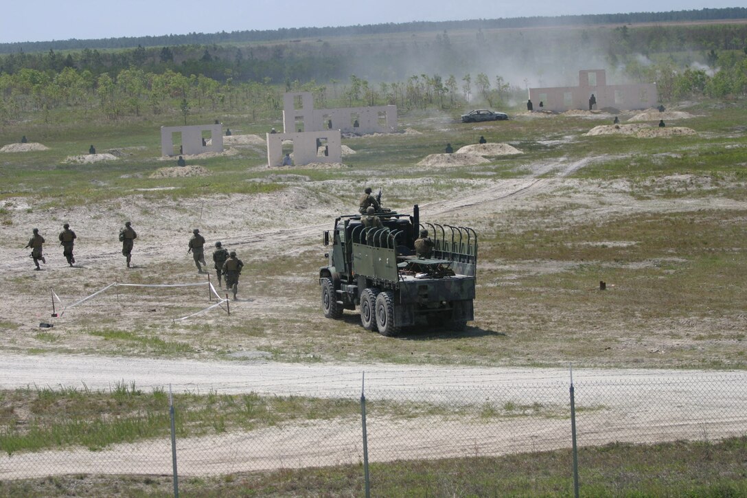 MARINE CORPS BASE CAMP LEJEUNE, N.C. (May 25, 2005) – Infantry Marines with 2nd Battalion, 6th Marine Regiment, 2nd Marine Division demonstrated new training capabilities here May 14, which when implemented, can help Marines combat this threat in the future.  The Marines performed convoy drills at Observation Post 2 as part of the new Convoy Operations Course displaying the beginnings of a new, more realistic training facility.  ::n::The course simulates near and far ambushes where a vehicle goes down and Marines have to dismount and attack.  There are also simulated hostages and the Marines have to react to insurgents using civilians as shields.  Photo by Pfc Terrell A Turner