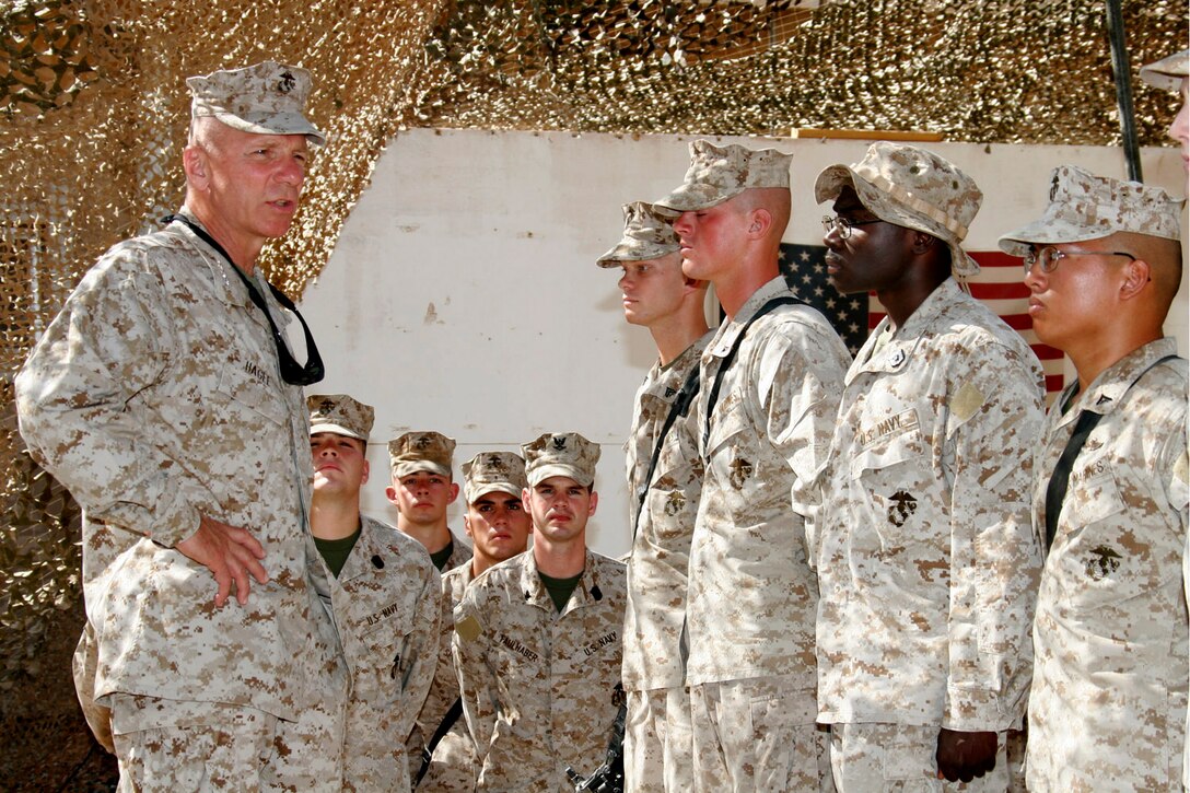 AL ASAD, Iraq ? General Michael W. Hagee, commandant of the Marine Corps, addresses Marines and sailors with Combat Logistics Battalion 2 before presenting them with his challenge coin July 25.  Some of the service members here were presented with the commandant?s coin for their outstanding contributions in support of Operation Iraqi Freedom.