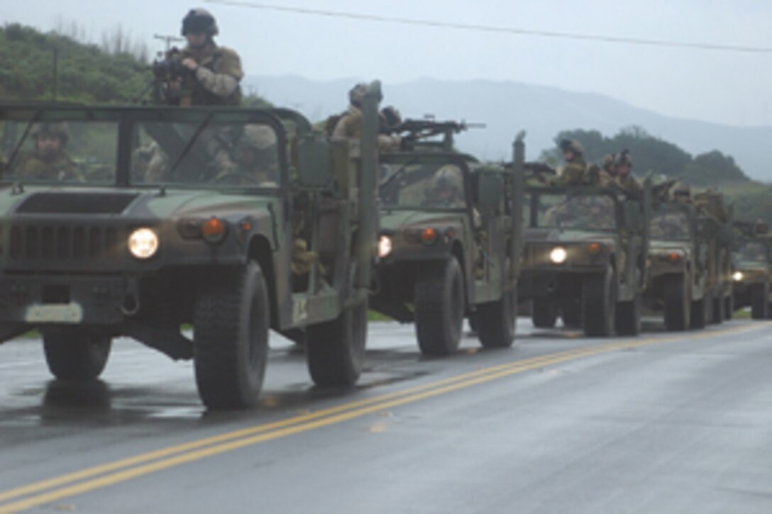 A convoy of Marines and sailors rolls through the streets near the Fleet Hospital Training Center. Photo by Lance Cpl. Joseph DiGirolamo.