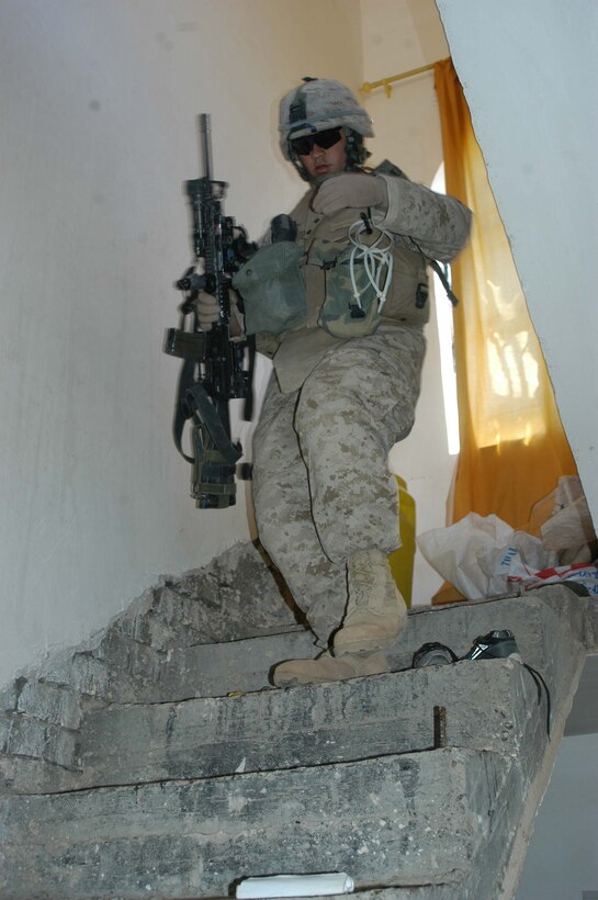 AR RAMADI, Iraq (March 25, 2005) -Twenty-five-year-old Sgt. Michael A. Lianoz, squad leader, 1st Squad, 1st Platoon, Company B, 1st Battalion, 5th Marines, of Los Angeles, walks down a crude flight of stairs in an Iraqi home he and his Marines searched. Leathernecks with 1st Platoon, Company B, 1st Battalion, 5th Marines, searched several houses in the western part of the city here March 25 for a man they suspect is a member of the jihad group Jaysh Mohamed, which is connected with producing improvised explosive devises and has been linked to several IED attacks. They also searched for illegal weapons, weapons caches and checked identification cards of the men in each house they searched. Photo by Cpl. Tom Sloan