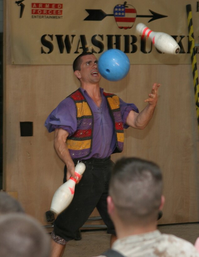 CAMP BLUE DIAMOND, AR RAMADI, Iraq - Juggler, comedian and award-winning motivational speaker, Dan Thurmon, demonstrates juggling skills during Operation Swashbuckle. Thurmon is a member of the four-man comedy show presented by Hack and Slash, who provided an explosive round of entertainment for more than 100 Marines, sailors and soldiers here serving with the 2nd Marine Division in support of Operation Iraqi Freedom.