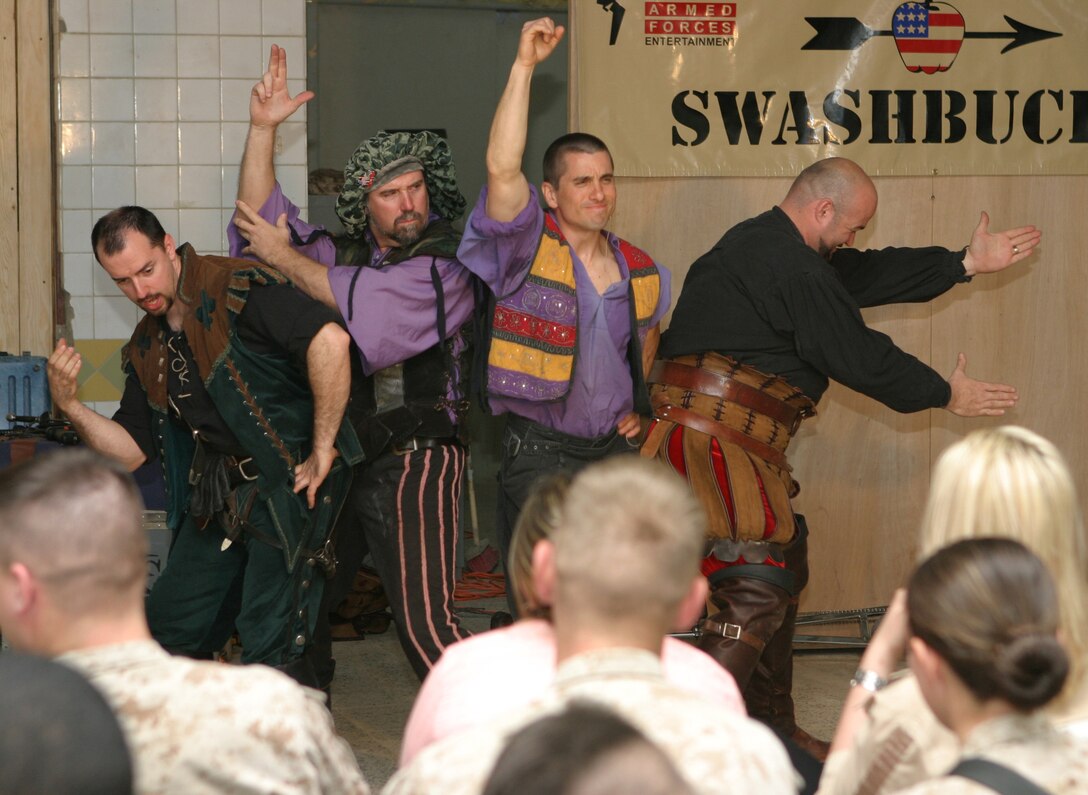 CAMP BLUE DIAMOND, AR RAMADI, Iraq - The members of the four-man comedy show (left to right) "Slash" Spencer Humm, Todd Key, Dan Thurmon and "Hack" John Davis do their Charlie's Angel pose during Operation Swashbuckle. The team, who like to think of themselves as a "Comic Expeditionary Force" provided an explosive round of entertainment for more than 100 Marines, sailors and soldiers here serving with the 2nd Marine Division in support of Operation Iraqi Freedom.