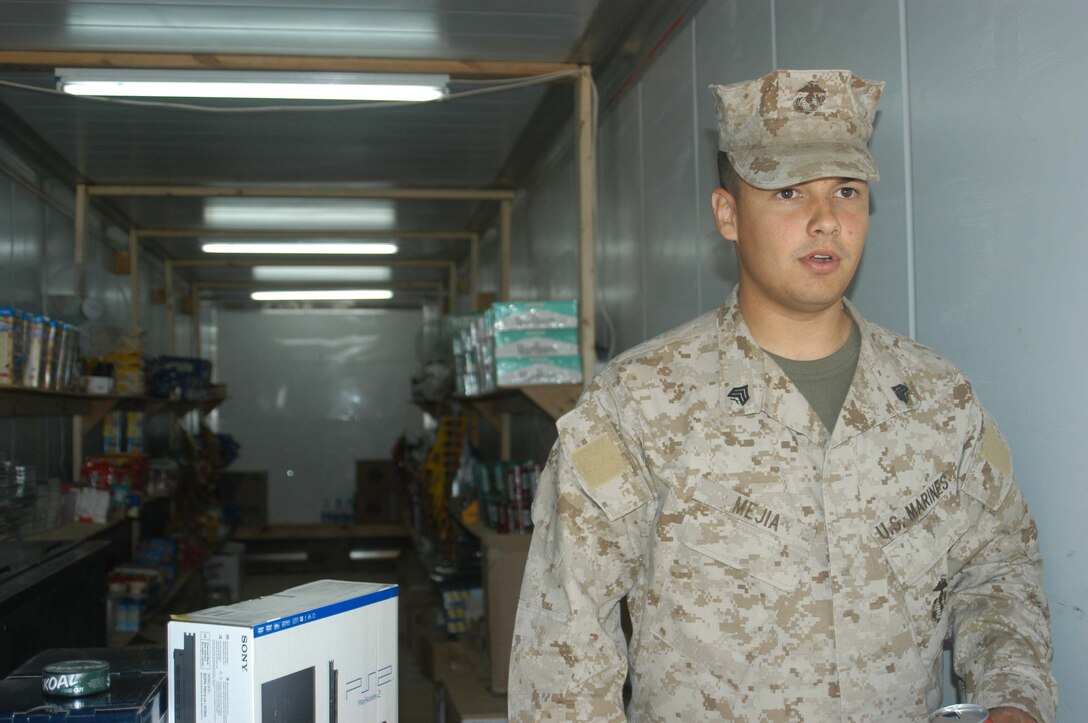 CAMP HURRICANE POINT, Ar Ramadi, Iraq (April 21, 2005) -Sergeant Miguel E. Mejia, retail store manager with Headquarters and Service Company, 2nd Force Service Support Group, 2nd Marine Division, gets ready to open the doors to the post exchange here and let Marines do their weekly-shopping. The 24-year-old Salinas, Puerto Rico native, runs the Warfighter Express Service Team, which provides exchange items for purchase, dispersing and postal services to warriors fighting on the frontlines of the urban battlefield. Each week, Mejia loads a 7-ton truck full of merchandise from the Camp Ramadi Exchange and visits Camps Snake Pit and HP where Marines with 1st Battalion, 5th Marines reside. Photo by Cpl. Tom Sloan