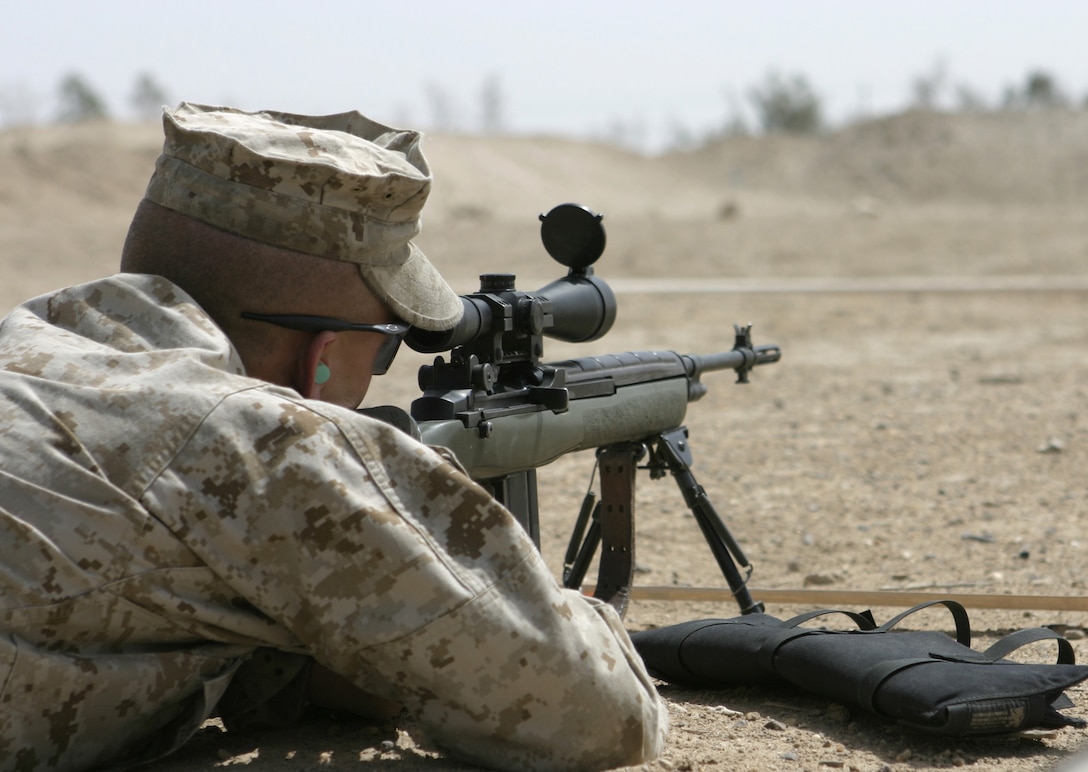 CAMP BAHARIA, Iraq - A Marine with 2nd Fleet Anti-Terrorism Security Team Company, Marine Corps Security Force Battalion, prepares to fire his M14 DMR sniper rifle during a battle sight zero exercise here April 21.  Unit members practiced adjusting their weapons' sights and firing the rifles aboard 1st Battalion, 6th Marine Regiment's range here to maintain their proficiency while providing security for convoys here.