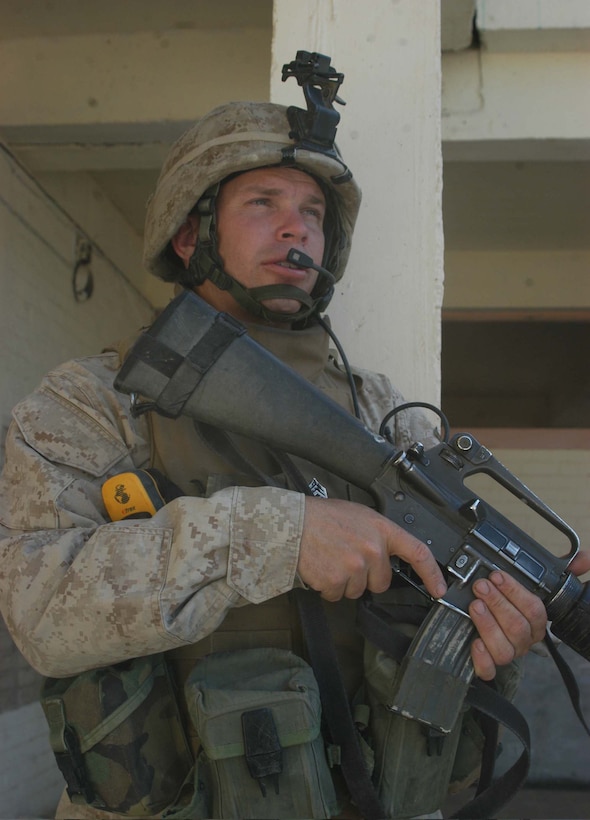 AR RAMADI, Iraq (May 26, 2005) - Sergeant Charles F. Crellin, a rifleman and the training noncommissioned officer for Company C, 1st Battalion, 5th Marine Regiment, provides security at the Al Jaod Elementary School here during a civil affairs mission with 4th Platoon, Company C and Marines with Team 1, Detachment 3, 5th Civil Affairs Group, which is direct support of the infantry battalion. The 28-year-old from Cincinnati and his fellow Marines surveyed the school and determined what repairs and supplies are needed. Photo by: Cpl. Tom Sloan