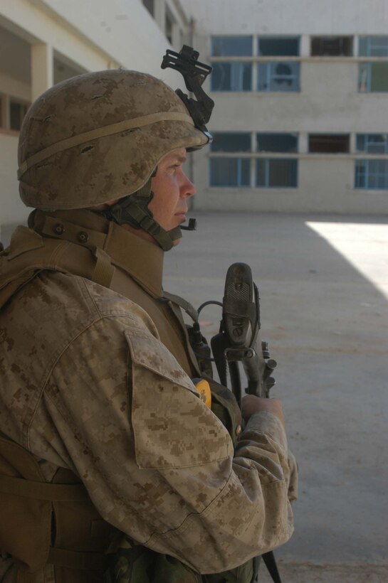 AR RAMADI, Iraq (May 26, 2005) - Sergeant Charles F. Crellin, a rifleman and the training noncommissioned officer for Company C, 1st Battalion, 5th Marine Regiment, provides security at the Al Jaod Elementary School here during a civil affairs mission with 4th Platoon, Company C and Marines with Team 1, Detachment 3, 5th Civil Affairs Group, which is direct support of the infantry battalion. The 28-year-old from Cincinnati and his fellow Marines surveyed the school and determined what repairs and supplies are needed. Photo by: Cpl. Tom Sloan
