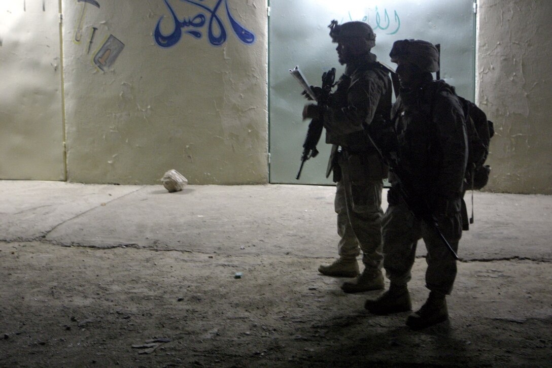 Haditha, Al Anbar, Iraq (May 26, 2005) - Platoon Commander Sean M. O'neill, 28 of Sewickly, Penn., with 3/25, 1st platoon pauses to speak with Marine during a nightpatrol for an operation here recently.  (Official USMC photo by Cpl. Ken Melton)