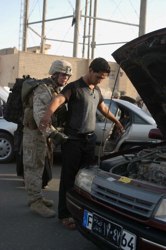 AR RAMADI Iraq (July 25, 2005) -Corporal Michael S. Goeringer, an assault man with 3rd Squad, 2nd Platoon, Company A, 1st Battalion, 5th Marine Regiment, searches an Iraqi man during a mission in the city here July 25. Goeringer and fellow Marines with the Camp Pendleton, Calif., -based infantry battalion conducted a battalion-wide operation in the city's marketplace, where they searched vehicles and personnel for weapons and improvised explosive making material. Photo by: Cpl. Tom Sloan