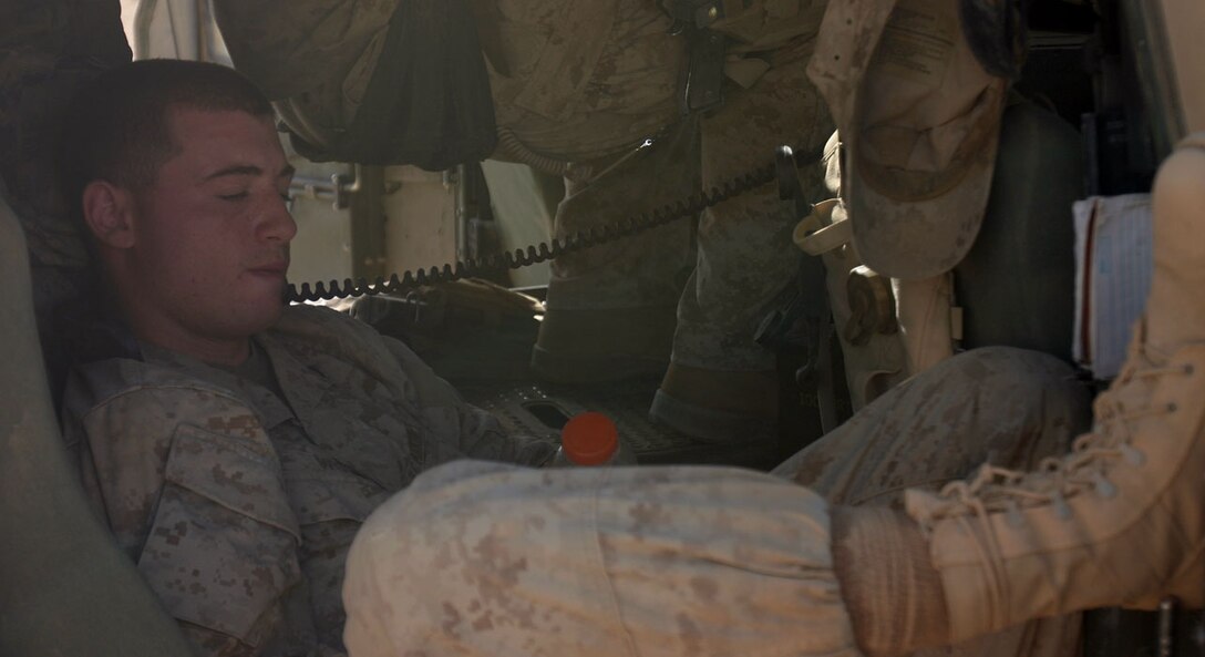 CAMP AL QA'IM, Iraq (Sept. 26, 2005) -- Quincy, Mass., native Lance Cpl. Collin T. Wolf, radio operator, 1st Mobile Assault Platoon, Weapons Company, 3rd Battalion, 6th Marine Regiment, Regimental Combat Team -2, monitors the radios during some down time while on a mission.  (Official U.S. Marine Corps photo by Sgt. Jerad W. Alexander)