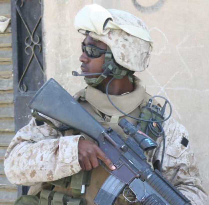 Cpl. Boldrick A. Wisdom, a 23-year-old Palm Beach, Florida native team leader looks back at his teammates in 1st squad, 4th Platoon, Company F, 2nd Battalion, 6th Marine Regiment during a patrol conducted as part of Operation Liberty Express. The operation was conducted to provide security for the referendum voting held in Iraq on Oct. 15.