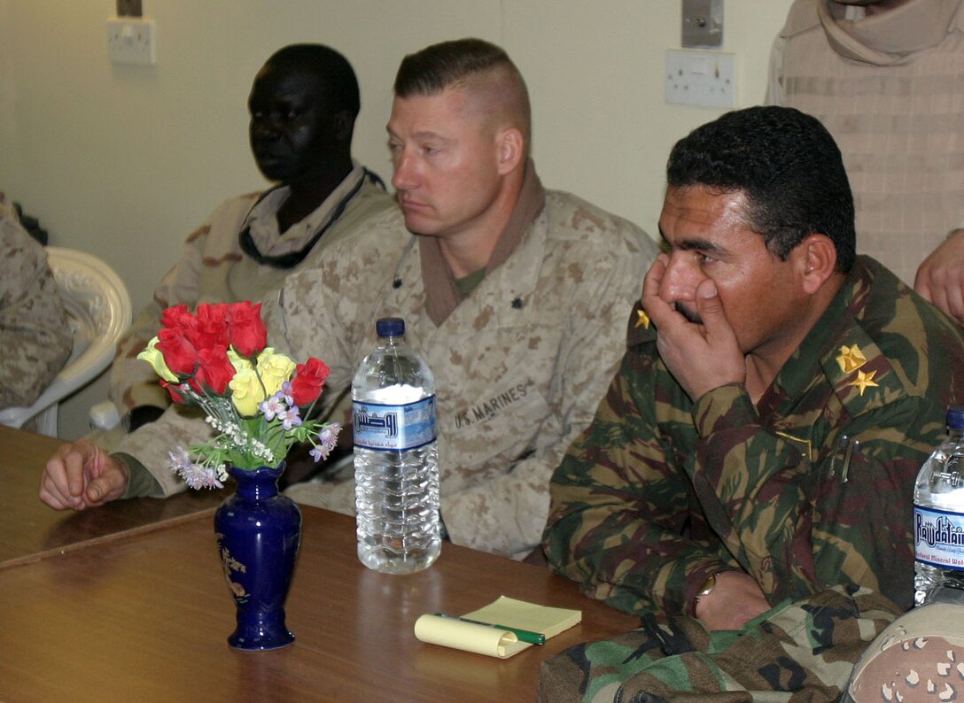 CAMP AL QA'IM, Iraq (Nov. 26, 2005) - Lieutenant Col. Julian D. Alford, commanding officer, 3rd Battalion, 6th Marine Regiment, Regimental Combat Team - 2, stis with the local Iraqi Army commander during a recent meeting with local Iraqi officials.  (Official U.S. Marine Corps photo by Sgt. Jerad W. Alexander)