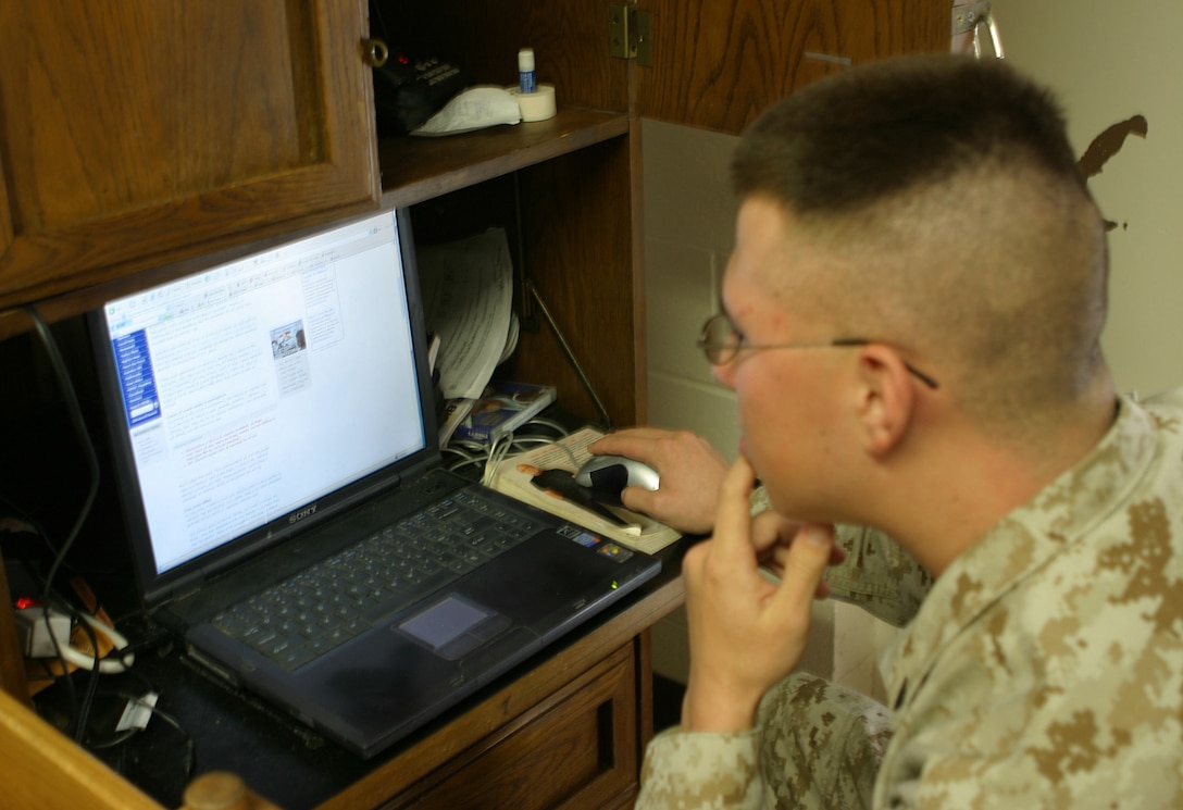 MARINE CORPS BASE CAMP LEJEUNE, N.C. (January 24, 2005) - Cpl. Chris X. Bowman, a tactical data communicator, with 2d Marine Division G-3, is one of many Marines responsible for managing the division website for Marines deployed to Iraq. His job is to make sure the information, points of contact and news is current.  Official Marine Corps photo by Pfc. Terrell A. Turner released.